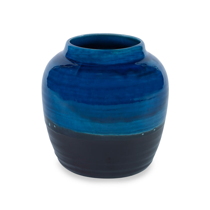 Aries Vase, Small QR-16964.BLKBLUE.0 by CuratedKravet CuratedKravet A handpainted, earthenware vase with a reactive blue and black glaze. Due to the handmade nature of this product, variation is to be expected from piece to piece. This vase is not watertight. Portugal HANDWASH ONLY. </p><p>Dimensions: Length 7, Height 7, Width 7 Ceramic - 100% - Fabric Carolina -