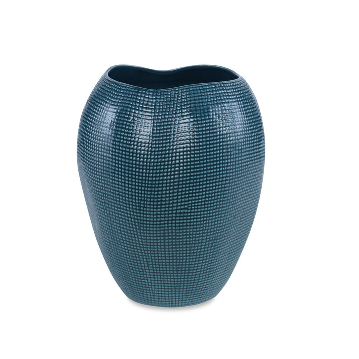 Lennon Vase QR-20693.DRKGRN.0 by CuratedKravet CuratedKravet An organically shaped earthenware ceramic vase detailed with sisal-like texture and a dark teal green reactive glaze. Due to the handmade nature of this vase, variation is to be expected. Portugal </p><p>Dimensions: Length 9.5, Height 11, Width 9.5 Ceramic - 100% - Fabric Carolina -