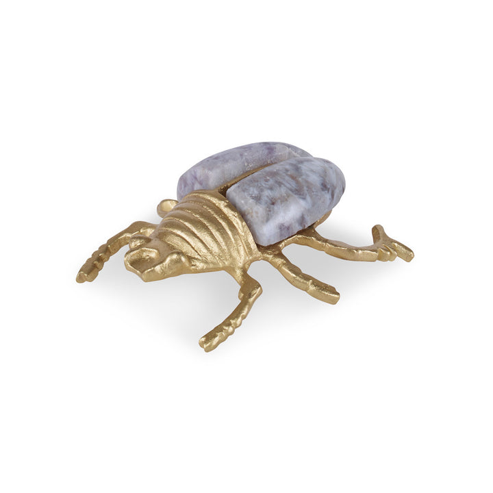 Juna Brass Beetle QR-21397.GLDAMYTH.0 by CuratedKravet CuratedKravet A decorative beetle sculpture made of brass and amethyst stone. India </p><p>Dimensions: Length 3, Height 1, Width 2.75 Brass - 50%, Stone - 50% - Fabric Carolina -