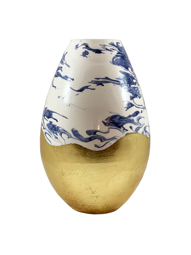 Umbria Vase QR-22010.NAVYGOLD.0 by CuratedKravet CuratedKravet A porcelain vase featuring a swirled navy and white painted design, contrasted by a gold leafed bottom half. Due to the handmade nature of this vase, variation is to be expected. Italy DUST LIGHTLY WITH A SOFT, DRY CLOTH. </p><p>Dimensions: Length 9, Height 14, Width 9 Porcelain - 100% - Fabric Carolina -