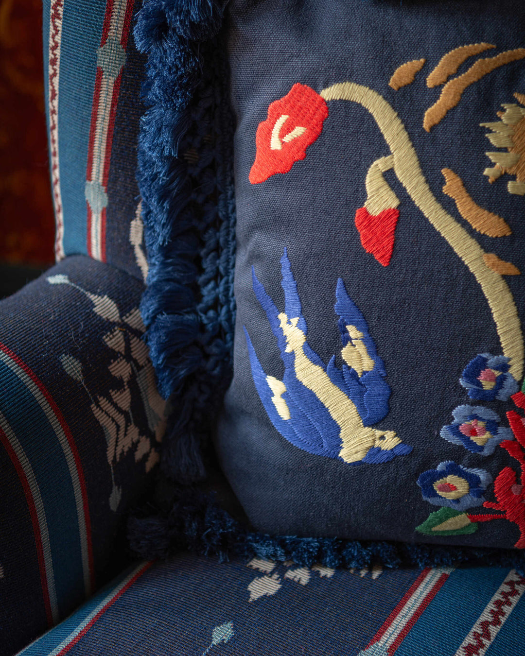 A SWALLOW'S HORIZON embroidered cushion (LC40265) by Mind The Gap | LC40265 | TRANSYLVANIAN RHAPSODY | 50 x 50 cm / 20 x 20 in | Blue, Yellow, Red | Fringes all around | Duck feather | 20% PA, 80% LI | Fabric Carolina | https://www.fabriccarolina.com/