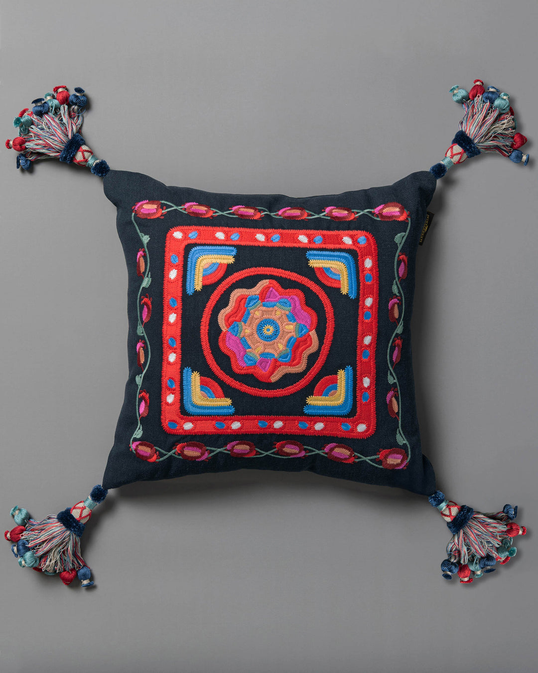 CARNIVAL embroidered cushion (LC40266) by Mind The Gap | LC40266 | TRANSYLVANIAN RHAPSODY | 50 x 50 cm / 20 x 20 in | Blue, Yellow, Pink, Red | Tasseled corners | Duck feather | 100% Linen | Fabric Carolina | https://www.fabriccarolina.com/