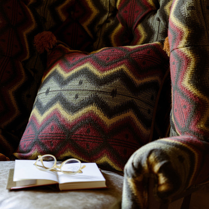Pyramidenspitze Cushion by Mind the Gap Designer Pillow TYROL APRES-SKI HOME COLLECTION 35% Cotton, 28% Polyacrylic, 23% Wool, 14% other fibres Made in Romania Leather piped edge and tasseled corners 20 x 20 in - Swanky Fabrics -