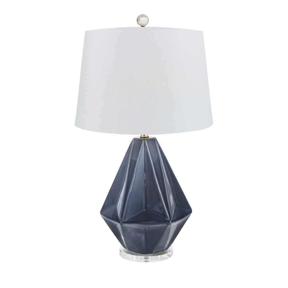 Liza Table Lamp QR-16105.MIDNIGHT.0 by CuratedKravet CuratedKravet A faceted ceramic table lamp featuring a deep midnight blue finish and a clear acrylic base. Topped with a hardback ivory linen drum shade. Detailed with a clear crystal ball finial. Made in the USA. United States </p><p>Dimensions: Length 14, Height 25, Width 14 Ceramic - 50%, Linen - 40%, Brass - 5%, Crystal Stone - 5% - Fabric Carolina -