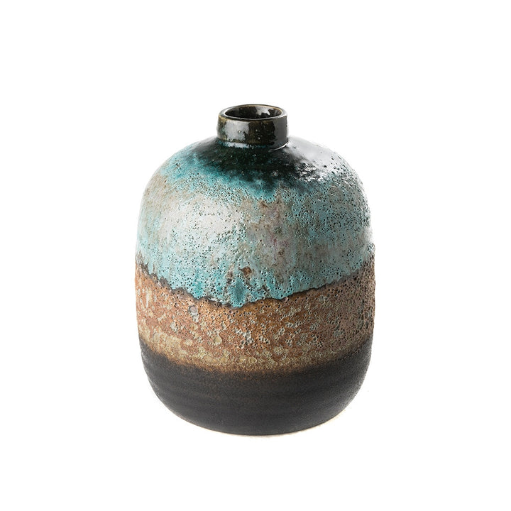Jocelyn Vase QR-19207.MULTIBLU.0 by CuratedKravet CuratedKravet A stoneware vase featuring a unique blue volcanic finish. Due to the handmade nature of this vase, variation is to be expected. China DUST LIGHTLY. </p><p>Dimensions: Length 6, Height 7.5, Width 6 Ceramic - 100% - Fabric Carolina -