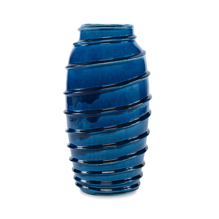 Kellie Vase QR-19337.DRKBLUE.0 by CuratedKravet CuratedKravet A decorative earthenware vase with a reactive blue crackled glaze. Each vase is handmade and unique. This vase is not watertight. Portugal DUST LIGHTLY. </p><p>Dimensions: Length 7.5, Height 14.75, Width 7.5 Ceramic - 100% - Fabric Carolina -