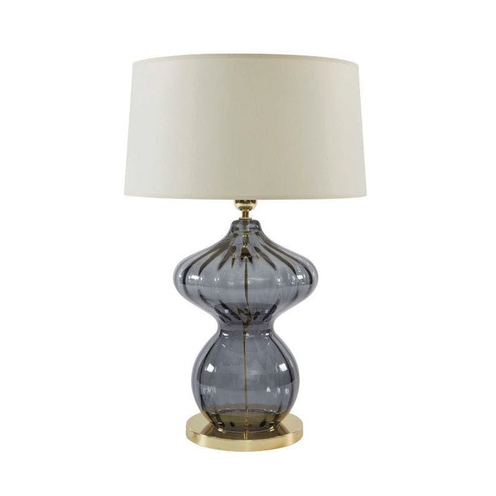 Beacon Table Lamp QR-21729.SMOKE.0 by CuratedKravet CuratedKravet A table lamp made of handmade blown glass. Detailed with polished brass metal accents. Topped with a cream parchment shade and an acrylic finial. Portugal DUST LIGHTLY WITH SOFT, DRY CLOTH. </p><p>Dimensions: Length 17, Height 25, Width 17 Glass - 60%, Paper - 30%, Metal - 10% - Fabric Carolina -