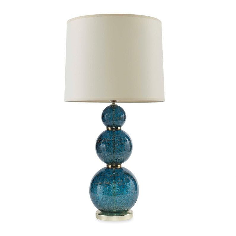 Madrona Table Lamp QR-21736.DRKBLUE.0 by CuratedKravet CuratedKravet A triple sphere table lamp made of handmade blown glass with metal particles incorporated to create a volcanic-like texture. Detailed with polished brass metal accents. Topped with a cream parchment shade and an acrylic finial. Portugal DUST LIGHTLY WITH A SOFT, DRY CLOTH. </p><p>Dimensions: Length 16, Height 29.5, Width 16 Glass - 60%, Paper - 30%, Metal - 10% - Fabric Carolina -